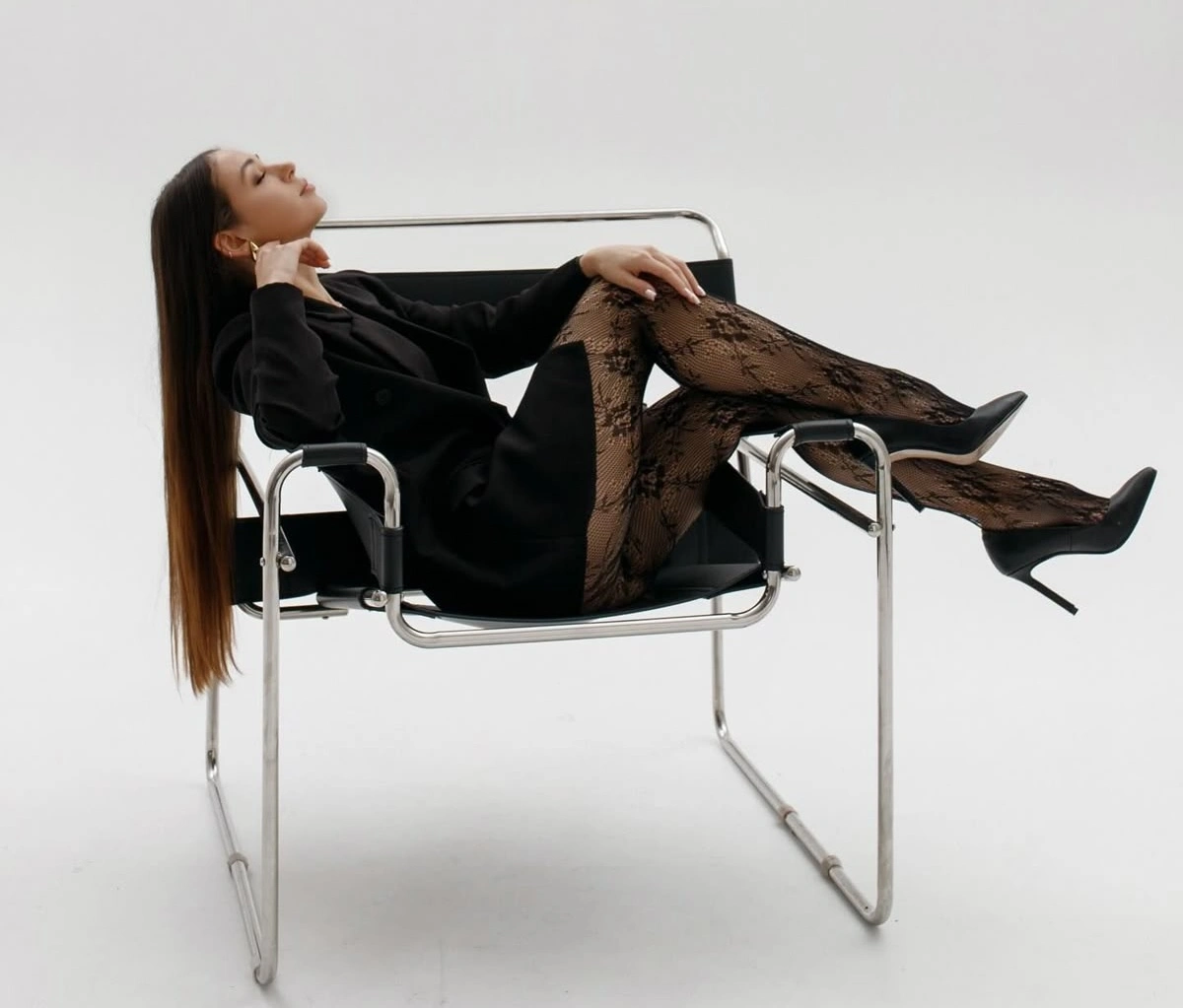 Client enjoying self-portrait session with Wassily Chair ins HQ Portraits Studio