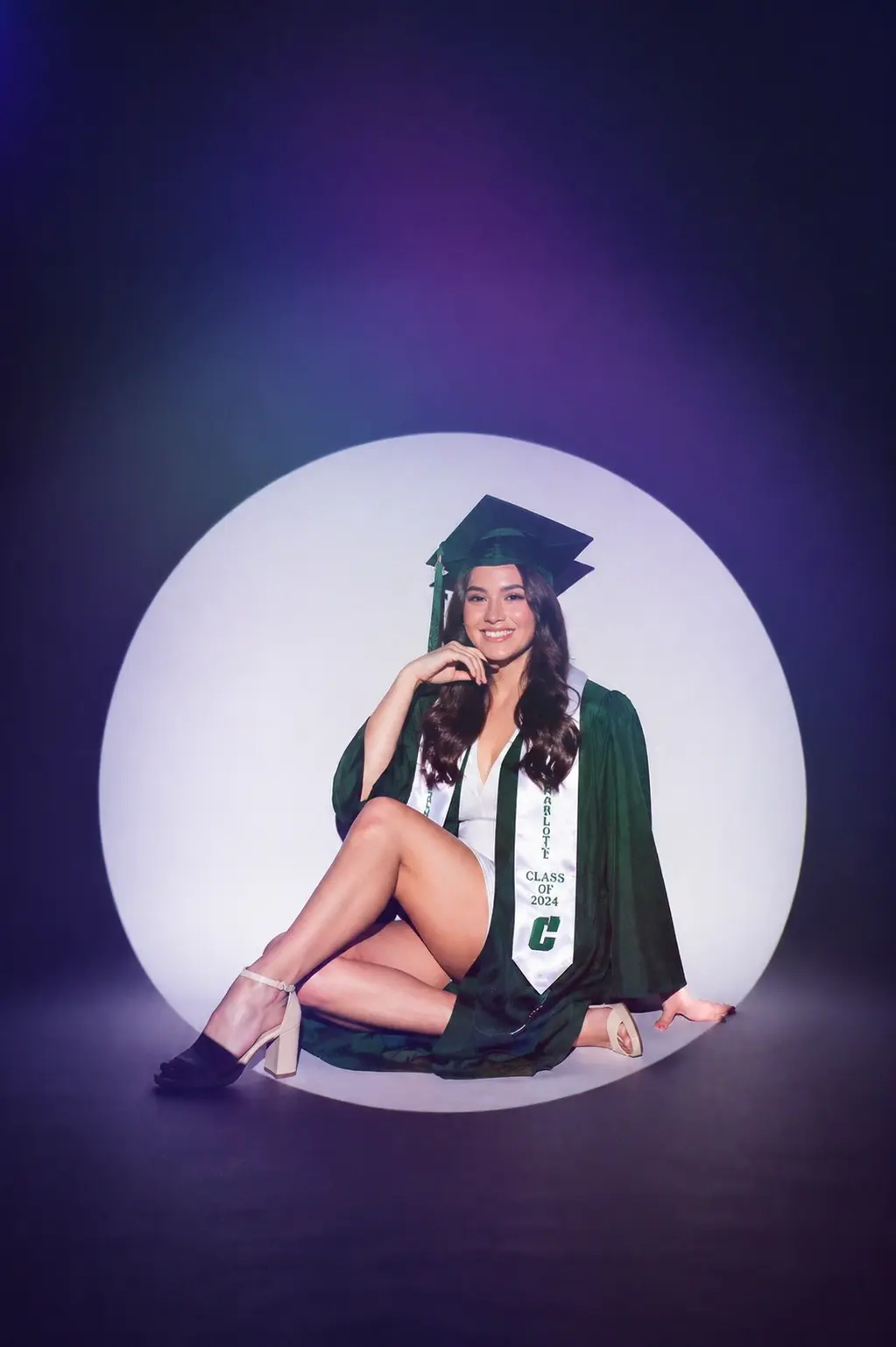 Senior graduate portrait with dramatic spotlight circle setup