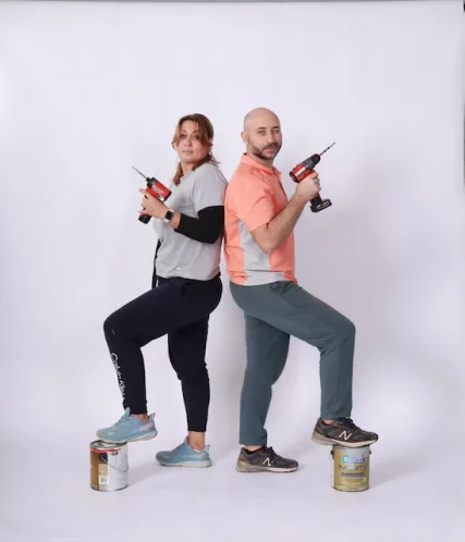 Leonid and Olga joking with drills and paint cans while building HQ Portraits