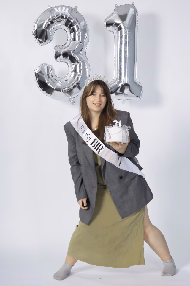 Share-ready vertical birthday portrait with sash, cake prop, and silver balloons