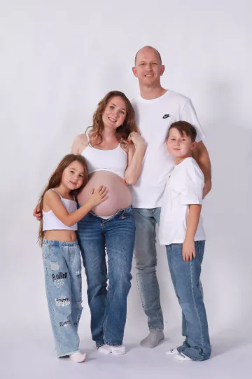 Family maternity photoshoot with partner and kids in matching outfits at HQ Portraits Charlotte