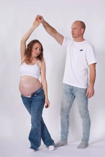 Expecting couple taking a playful maternity self-portrait with a wireless clicker at HQ Portraits Charlotte