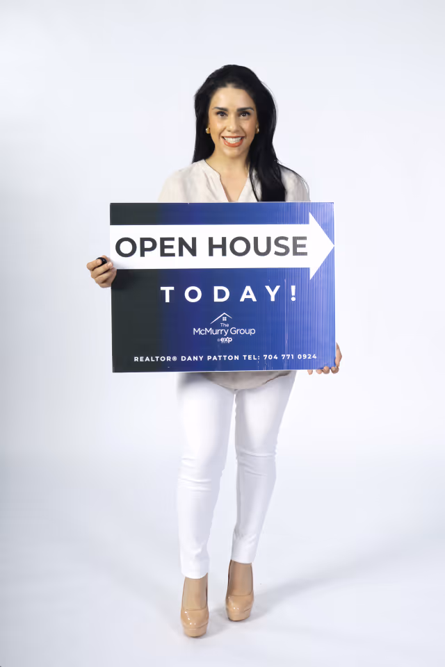Realtor holding an open house sign